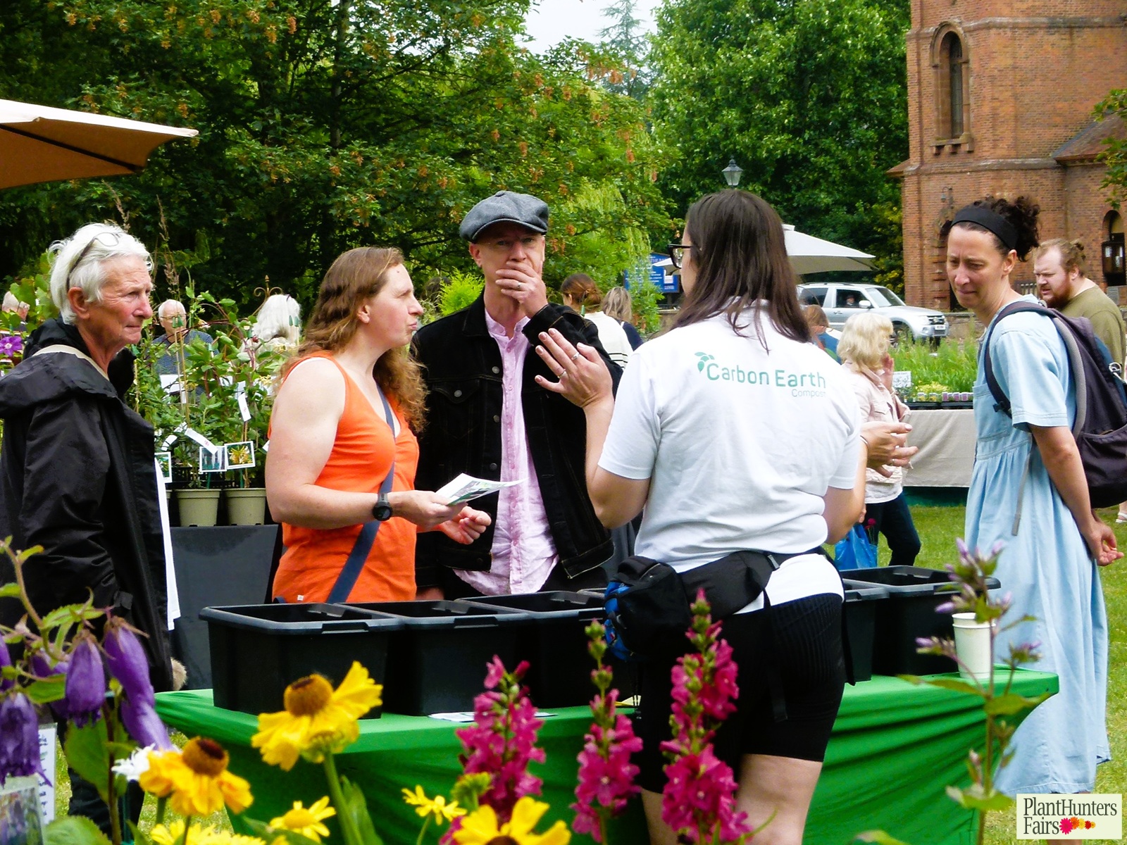 Jessica from Carbon Earth explaining her products to customers at a summer plant fair